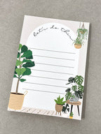 Home A6 notepad with "let's do this" header and potted plant illustrations lying flat