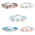 Meninas Bonitas Cork Colourful Ceramic Bead Handmade Bracelet 18x1cm – layout – five cork bracelets in dark brown, white, light blue, royal blue, and pink displayed on a white background.