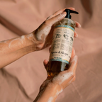 Syriana Quattro Olii Liquid Aleppo Soap 400ml - Hands washing with Liquid Aleppo Soap foam against a soft fabric background